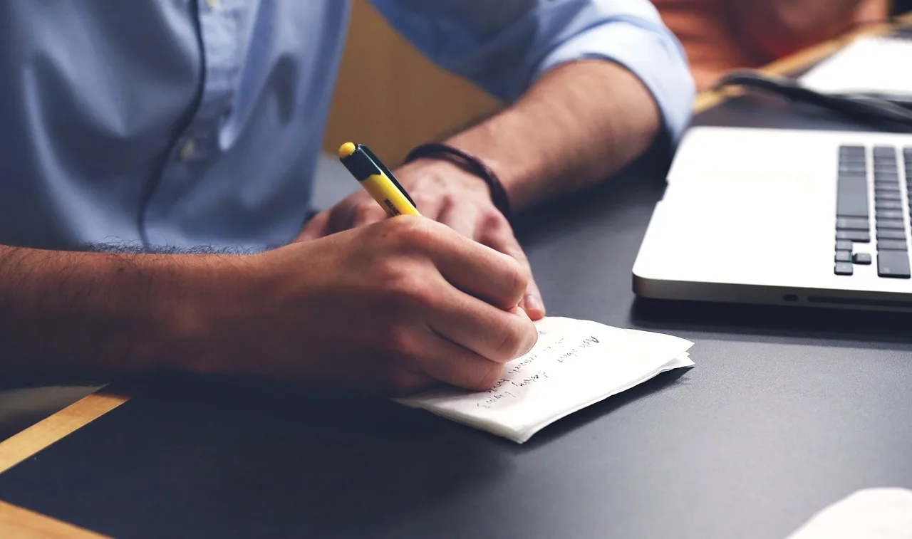 man, write, plan, desk, notes, pen, writing, taking notes, office, working, notepad, workspace, workplace, man, write, plan, writing, writing, writing, writing, writing, office, office, office, working. Talent agency client onboarding: the paperwork before first payment